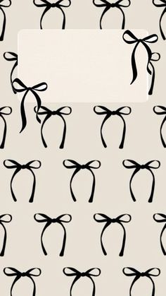 black and white bows on a gray background with a blank paper in the middle for text