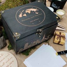 an open black box sitting on top of a table next to paper and other items