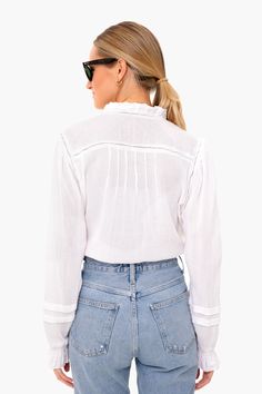 Inspired by a love of surf culture, brothers Alex and Mike Faherty founded a brand of sustainable, high-quality apparel for life's many adventures.Embrace casual bohemian vibes in this peasant style blouse. Featuring romantic blouson sleeves and delicate embroidery along on the neckline and chest, this relaxed and graceful top exudes laid back femininity.

Ladder Trim
Picot Ruffle Sleeves & Neck
Clip Dot Cuffs
Pearl Buttons
100% Cotton
Care: Machine wash cold, lay flat to dry Casual White Blouse With Boho Collar, Casual Long Sleeve Peasant Top For Beach, White Casual Top With Boho Collar, White Casual Tops With Boho Collar, Spring Vacation Long Sleeve Peasant Top, Summer Tops With Smocked Cuffs And Lantern Sleeves, Long Sleeve Peasant Top For Spring Vacation, Long Sleeve Tops With Boho Collar For Beach, Long Sleeve Boho Collar Tops For Beach