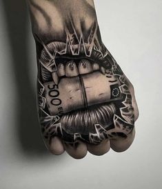 a person's hand with tattoos on it that has money coming out of them