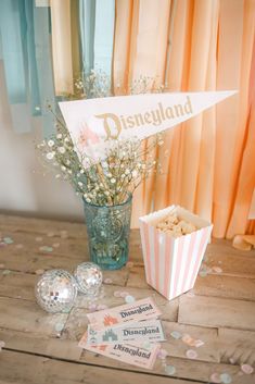 the table is set up with candy and confetti for disney land's birthday party