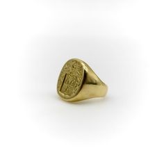 This 18k gold Tiffany & Co. Larter & Sons signet ring is hand carved with a heraldic family crest. The crest has a shield with three bell-like shapes sprouting flowers. Above the shield is a knight’s helmet topped with a feather and surrounded by scrolling foliate. The classic design of the crest suggests royalty and valor.  Larter & Sons was founded in 1865 and was renowned for their exquisite craftsmanship of men’s accessories. They expanded to include women’s jewelry in the early 20th century, using intricate techniques such as guilloche and enamelwork, and incorporating motifs inspired by nature. They collaborated with Tiffany & Co. to make jewelry such as cufflinks and signet rings. Tiffany & Co. would often consign well-known brands of the highest quality, including Larter & Sons. Formal Carved Yellow Gold Signet Ring, Luxury Carved Yellow Gold Signet Ring, Classic Carved Signet Ring For Formal Occasions, Luxury Yellow Gold Signet Ring With Coat Of Arms, Luxury Yellow Gold Coat Of Arms Signet Ring, Formal Gold Signet Ring With Coat Of Arms, Heirloom Gold Carved Signet Ring, Heirloom Oval Signet Ring With Coat Of Arms, Formal Carved Signet Ring In 14k Gold