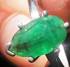 Imperfectly Perfect! This emerald came from a huge lot acquired in the late 70s. The natural inclusions in this stone along with the faceting on the back of the emerald make this ring so unique. This natural 1.56ct emerald is pear shaped cut and pavilion set (back of the stone is set face up). There is a natural clarity characteristic towards the lower tip of pear. Sterling silver mounting has five prongs and a v tip to protect the point of pear. High polished finish band tapers from 1.7 to 1.5 Oval Untreated Green Emerald Ring, Untreated Oval Green Emerald Ring, Anniversary Faceted Emerald Ring, Green Emerald Ring With Faceted Emerald Cut, Faceted Green Emerald Cut Emerald Ring, Green Faceted Emerald-cut Emerald Ring, Emerald Solitaire Ring, Aquamarine Solitaire Ring, Aquamarine Studs