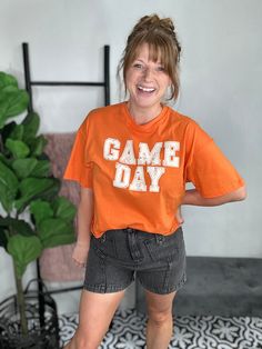 Get ready for some serious fun with our Orange Game Day Graphic Tee! Stand out in bright orange while showing your team spirit on game day. Perfect for wearing on a sunny day with short sleeves, this tee will make you the life of the party. Material: 100% Cotton Sizing: Small: Sizes 4-6 Medium: Sizes 8-10 Large: 12-14 can size down if between sizes Model Info: Opal: Size 8, 36DD, 5’7 (true to size M wearing a M) Annalise: Size 4, 5'1" (true to size S wearing a S) Orange Games, Skort Style, Books For Moms, Graphic Tops, Grey Wash, Team Spirit, Game Day, Cargo Shorts, Sport Outfits