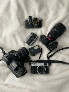 the camera is sitting on the bed next to other items that are in front of it