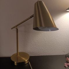 a desk lamp sitting on top of a black table