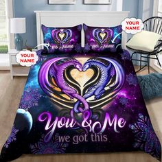 a bed with purple and blue comforter covers on it