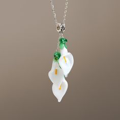 "This calla lily flower necklace are made of glass in lampwork technique. This unique and beautiful necklace have so many beautiful details, it bring freshness and elegance to every outfit! You will definitely get a lot of compliments on your new necklace, everybody loves it, and you'll love it too! Dimensions: total pendant height about 2 3/4 inch (70mm). Silver colored metal chain length is adjustable, 16\"-20\" inches (40-50cm). Materials: artist lampwork glass beads, metal fittings. Here's w Elegant Murano Glass Necklace For Gift, Elegant Murano Glass Necklaces For Gift, Elegant Glass Flower Necklaces, Elegant Flower-shaped Glass Necklaces, Elegant Flower Shaped Glass Necklaces, Elegant Glass Flower Necklace, Elegant Glass Flower Pendant Necklace, White Flower Shaped Glass Jewelry, Elegant Green Murano Glass Necklace