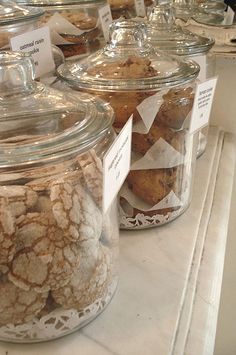 jars filled with baked goods sitting on top of a counter