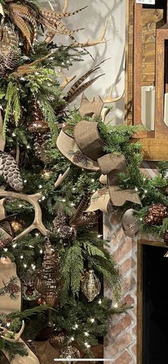 a christmas tree decorated with pine cones and burlucks in front of a fireplace