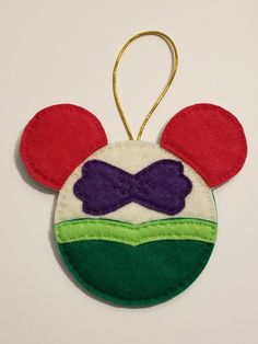 a mickey mouse ornament hanging on a wall