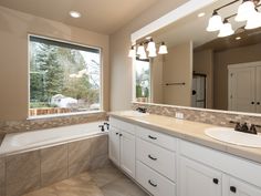 a large bathroom with two sinks and a bathtub