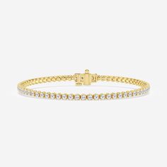 a yellow gold bracelet with white stones on the front and back ends, set against a plain background