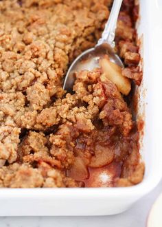 a close up of food in a pan with a spoon