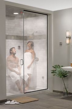 a man and woman in the shower looking at each other