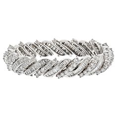 This platinum midcentury round and baguette cut diamond bracelet is a truly unique and exquisite piece of jewelry. The combination of round and baguette cut diamonds creates a mesmerizing sparkle and shine that is truly remarkable. This bracelet is also crafted in platinum, a metal that is extremely durable and highly resistant to tarnishing, so you can be sure that it will last a lifetime. Diamond Carat Weight: 16.50cttw. Quality: F-G color, VS-SI clarity. Wrist size 6 inches. Modern Bracelets, Expensive Jewelry, Baguette Cut Diamond, Baguette Cut, Diamond Bracelet, Metallica, Diamond Cuts, Platinum, Jewelry Bracelets