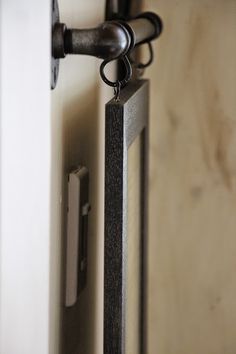 an open door with a handle on it and a key chain hanging from the front