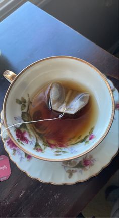 a tea cup with a spoon in it on a table