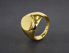 This listing is for 14k Gold Filled signet ring the base metal is 925 sterling silver. this is a timeless classic that goes with just about any look and will look great both on man and woman. What is Gold Fill? It's an actual layer of gold-pressure bonded to another metal. Gold filled is not to be confused with gold plating as filled literally has 100% more gold than gold plating. Gold filled is much more valuable and tarnish resistant. It does not flake off, rub off or turn colors. As a matter Modern Shiny Finish Signet Ring, Gold Dome Ring With Polished Sterling Silver Finish, Modern Hallmarked Round Signet Ring, Oval Rings With Shiny Finish For Gift, Gold Oval Dome Ring In Sterling Silver, Shiny Finish Signet Ring As Gift, Gold Signet Ring With Polished Thick Band, Gift Signet Ring With Shiny Finish, Gold Sterling Silver Ring With Shiny Finish