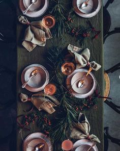 a table topped with dishes and cups filled with saucers on top of a wooden table