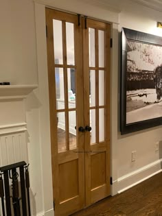 an empty living room with wood floors and french doors