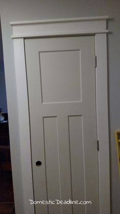 a white door in the corner of a room