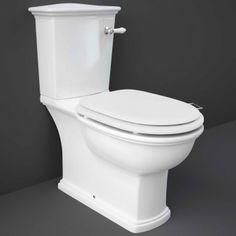 a white toilet sitting on top of a gray floor