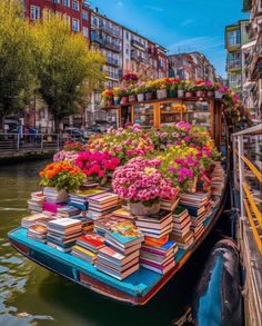 a boat filled with lots of books floating down a river