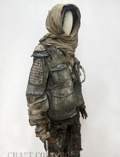 a mannequin dressed in an army outfit with hood and goggles on it's head