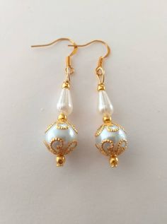 Victorian gold Pearl wedding earrings gold earrings Victorian earrings filigree Earrings Bohemian earrings bridal white pearl gift for her Beautiful Victorian filigree gold tone ornaments and crystal white pearls earrings. Filigree earrings.  Dangle earrings. Drop earrings . Boho earrings. Bohemian earrings . Gold - tone and crystal  pearls Boho earrings . Vintage style earrings . Oriental earrings . Baroque earrings . Antique style earrings .   Wedding earrings. Bridal earrings. We can make the same style beautiful jewelry set if you want - necklace, earrings and bracelet. If you want that, send us a convo/message/. FREE SHIPPING  Material : gold tone ornaments beads, crystal white pearls, plastic beads. Length with hooks : 2 ( 5 cm) If you have any question, please contact me ! Thank you Delicate White Gold-plated Pearl Earrings, White Gold-plated Pierced Pearl Earrings, Delicate White Gold Plated Pearl Earrings, White Gold Plated Pierced Pearl Earrings, White Gold Plated Dangle Bridal Earrings, White Gold-plated Dangle Pearl Earrings, Handmade Gold-plated Bridal Earrings For Wedding, White Intricate Design Dangle Earrings, White Gold Plated Dangle Pearl Earrings