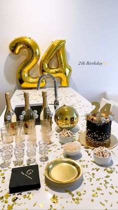 the table is set up with champagne, cake and other confetti for an anniversary celebration