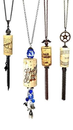 four different types of necklaces hanging from chains with words on them and charms attached to them