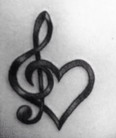 a black and white photo of a treble in the shape of a heart tattoo