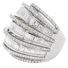 This large ornate cocktail ring is beautifully created with nine diamond set bands all constructed into a domed design. The bands alternate with claw set round brilliant cut diamonds and channel set baguette cut diamonds creating a lovely contrast with this ring. This spectacular piece has a total of 286 diamonds coming to an approximate total weight of 3.50 carats all mounted in 18 carat white gold. Stamped 18K 750. UK finger size 'N'. Radiant Ring, Cluster Ring Set, Bling Ideas, Gold Cocktail Ring, Gold Cocktail, Baguette Cut Diamond, Domed Ring, Dress Rings, Channel Set