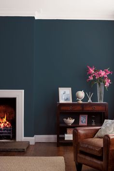 a living room with blue walls and a fireplace