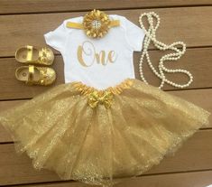 This listing is for Golden first birthday outfit . 3 piece set includes 1. Bodysuit / T-shirt 2. Golden soft tutu 3. Headband Pearls and shoes are not included but can be purchased separately. Name can be added on the bodysuit. Please leave a note in the note to seller box upon checkout for personalization. Bodysuit used is carter's brand . Carter's Bodysuit is Crafted in babysoft cotton, Easy to change with Nickel-free snaps on reinforced panels . All outfits are made to Order and standard PROC 1st Birthday Golden Birthday, The Golden One First Birthday, The Golden One Birthday, One Year Old Golden Birthday Party Ideas, Golden One Birthday Girl, Golden Birthday One Year Old, Golden 1st Birthday, Golden 1st Birthday Girl, Golden One Birthday