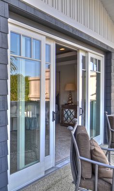 an outside patio with chairs and sliding glass doors