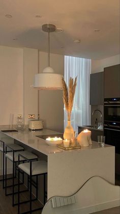 a kitchen with an island and candles on the counter