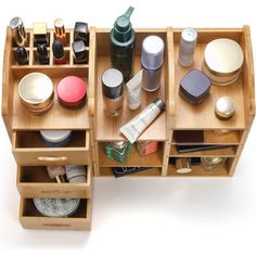 an assortment of makeup and beauty products in wooden drawers