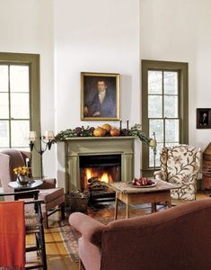 a living room filled with furniture and a fire place in the middle of a room