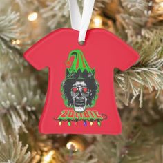 a blue ornament hanging from a christmas tree with an image of a clown on it