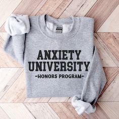 Anxiety University Honors Program Sweatshirt - Mental health crewneck in college font design. Hoping for a T-SHIRT?  Wish I had a different COLOR or SIZE?  Please ask!  I will do my best to accommodate! About Our Sweatshirts Ideal for any situation, this premium and soft Unisex sweatshirt fits like a well loved favorite.    .: Ribbed knit collar retains its shape even after washing  .: No itchy side seams  .: 50% Cotton 50% Polyester - A perfect blend for smooth printing .: Medium-heavy fabric Vinyl Sweatshirt Ideas Cricut, Positive Sweatshirts, Popular Sweatshirts, Sweatshirt And Shirt Outfit, Sassy Sweatshirts, Masters Program, College Font, College Sweater, Sweatshirt Fits