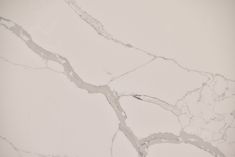 a white marble floor with grey lines on the top and bottom, as well as an abstract design