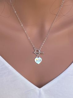 "*Sterling Silver heart tag Toggle Heart Necklace All Metal Components onto Sterling Silver. IT is made of .. -Sterling Silver Toggle Clasp, -Sterling Silver  Heart Tag  pendent , -Sterling Silver cable chain. -Total length will be 16\", 17\", 18\", 19\", 20\", 21\", or 22\" , depend on customer's request -Come up with ribbon gift box, free massage card, and  -One set of Care instruction package . -it  can be stamped  custom initial. -All quantities are available for special occasion. MORE HEART NECKLACE https://www.etsy.com/shop/rainbowearring1/search?search_query=+heart&order=date_desc&view_type=gallery&ref=shop_search  NOTE  ~ Please leave initial which you desired in the \"message to Seller\" box when you checkout. ~ Letters available in UPPERCASE(3mm) or LOWERCASE(1.5mm) ~ Numbers, op Toggle Clasp Necklace, Heart Pendent, Ribbon Gift, Heart Lock, Toggle Necklace, Clasp Necklace, Anniversary Gifts For Wife, Rainbow Earrings, Custom Initials