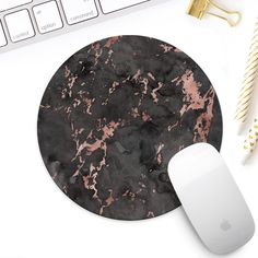 a mouse pad with pink and black marble on it