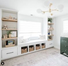 a white room with lots of shelves and baskets on top of the shelf, along with a large rug