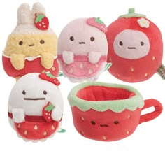 four small stuffed animals sitting next to each other in front of a cup and saucer