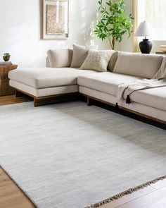 a living room with a large white sectional couch