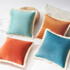 four different colored pillows sitting on top of each other