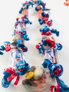 an assortment of candy wrapped in cellophane with spiderman decorations on it, along with other candies